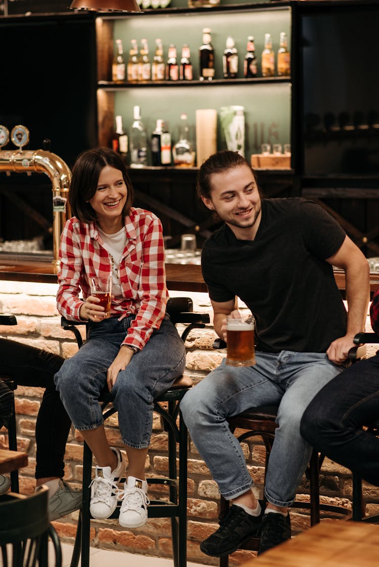 A Man In Black Crew Neck T-shirt Sitting On A Bar Stool