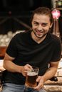 Man in Black V Neck T-shirt Holding Clear Drinking Glass