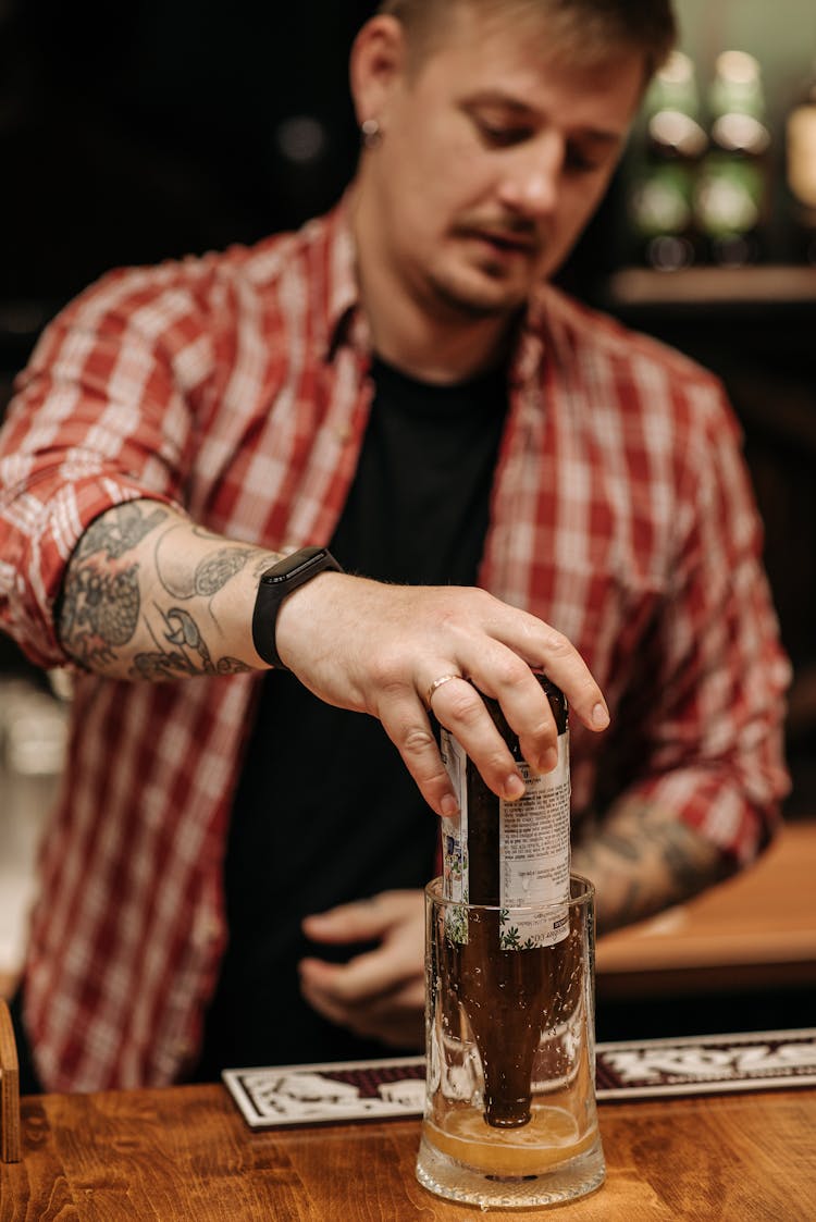 A Man Pouring Beer In A Glass