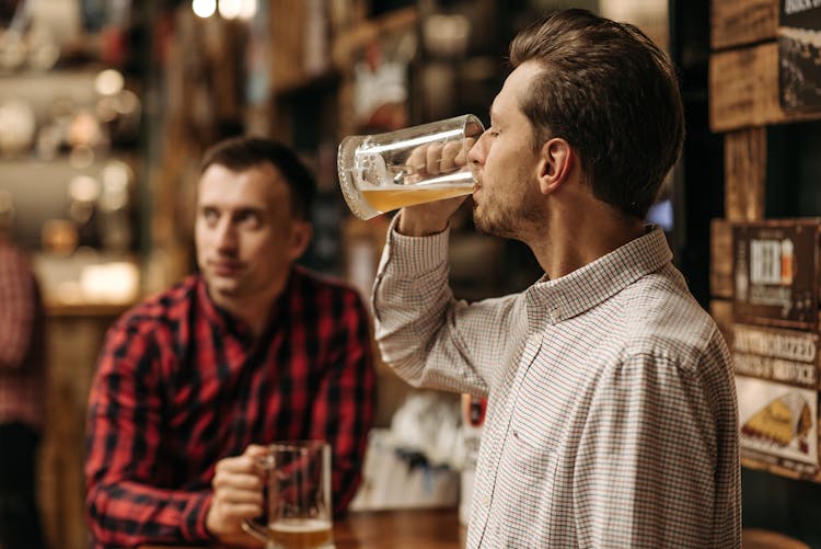 Man Drinking  Beer From A Beer Glass