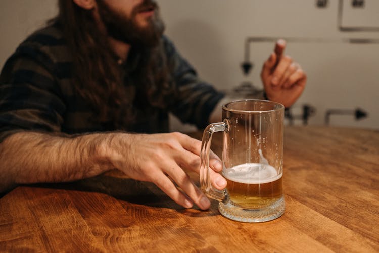 Man Holding A Glass Of Beer