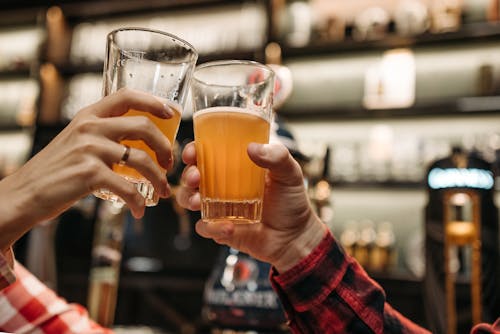Free Hands Holding Glasses of Beer Stock Photo