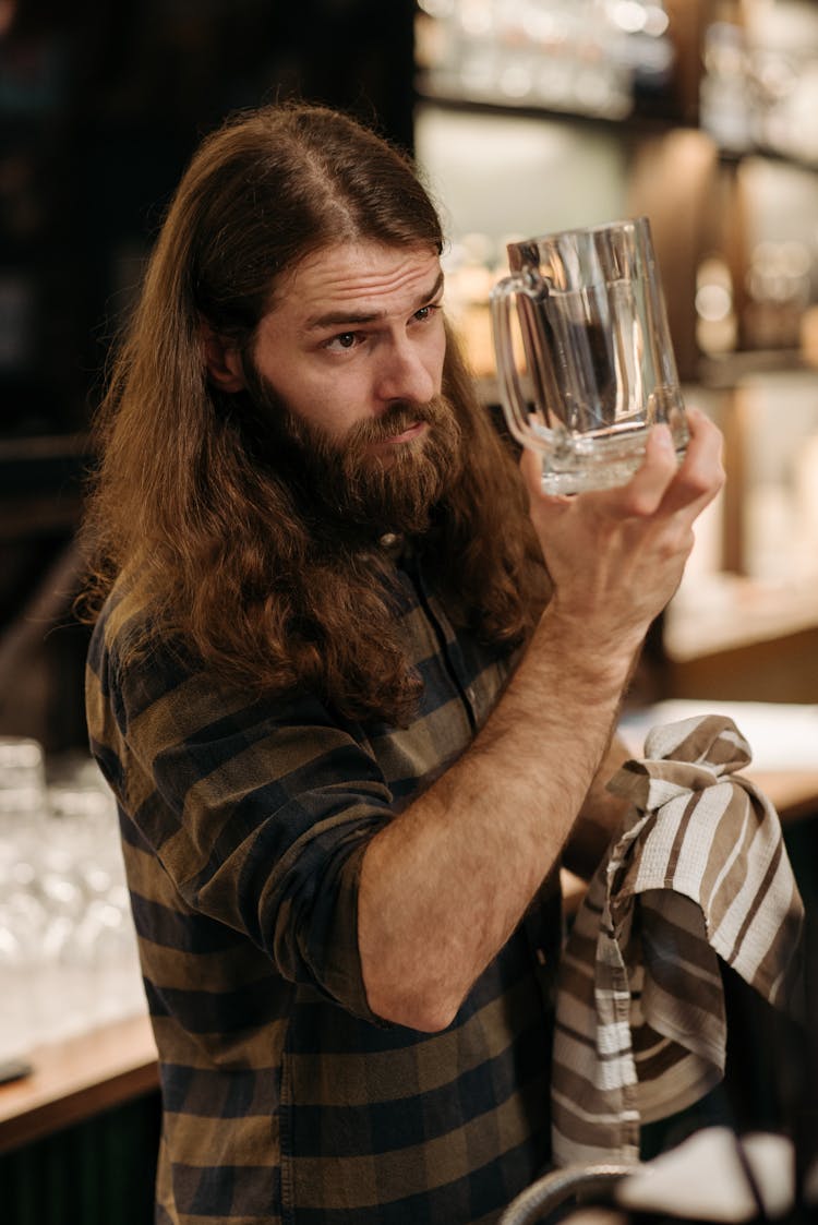 A Bearded Man Holding A Beer Glass