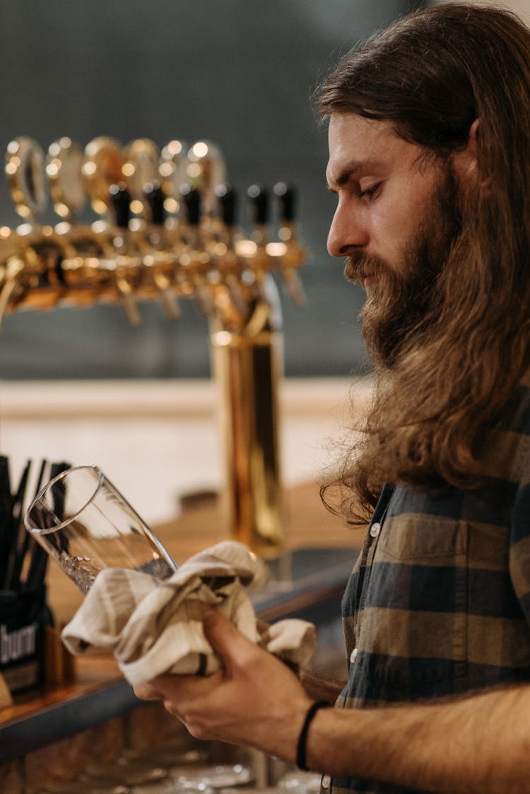 Man Cleaning A Drinking Glass