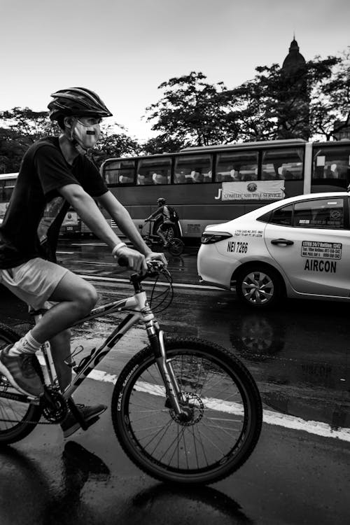 Grayscale Photo of a Cyclist on the Road