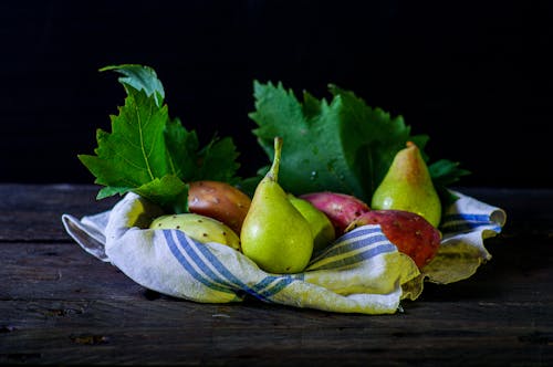 Fruits on a Fabric Laid on Wooden Table