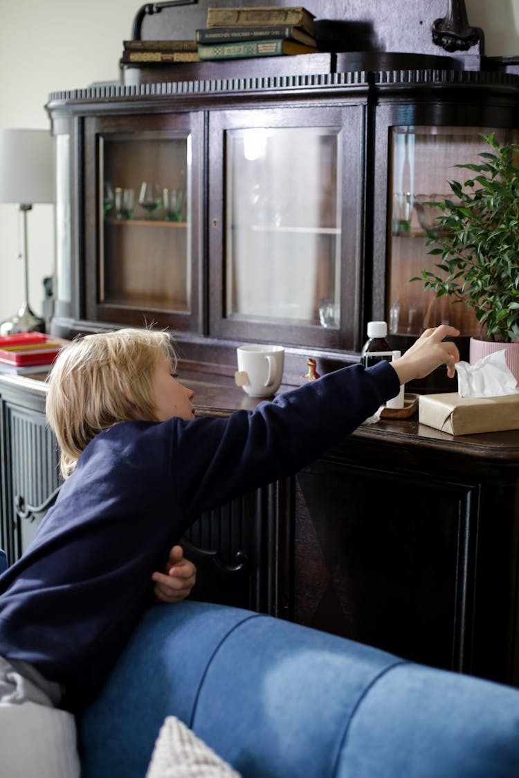 Kid Reaching For A Tissue