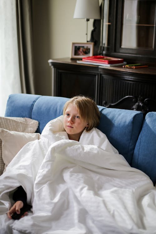 Free A Boy Sitting on the Couch Stock Photo