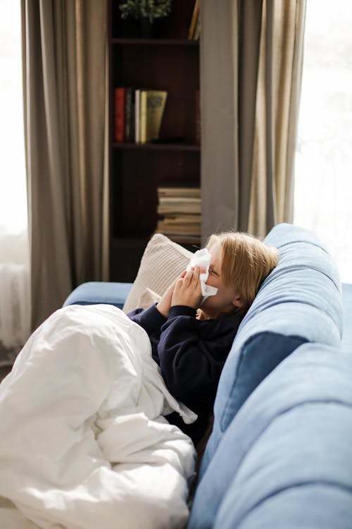 Free A Boy Sitting on the Couch Stock Photo