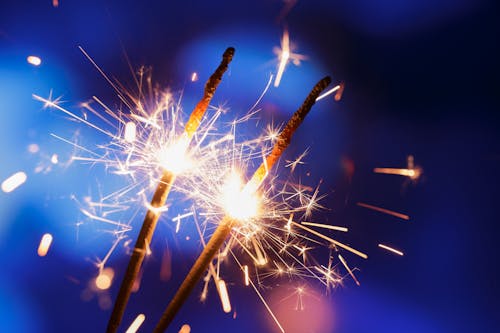 Selective Focus Photo of Two Burning Sparklers