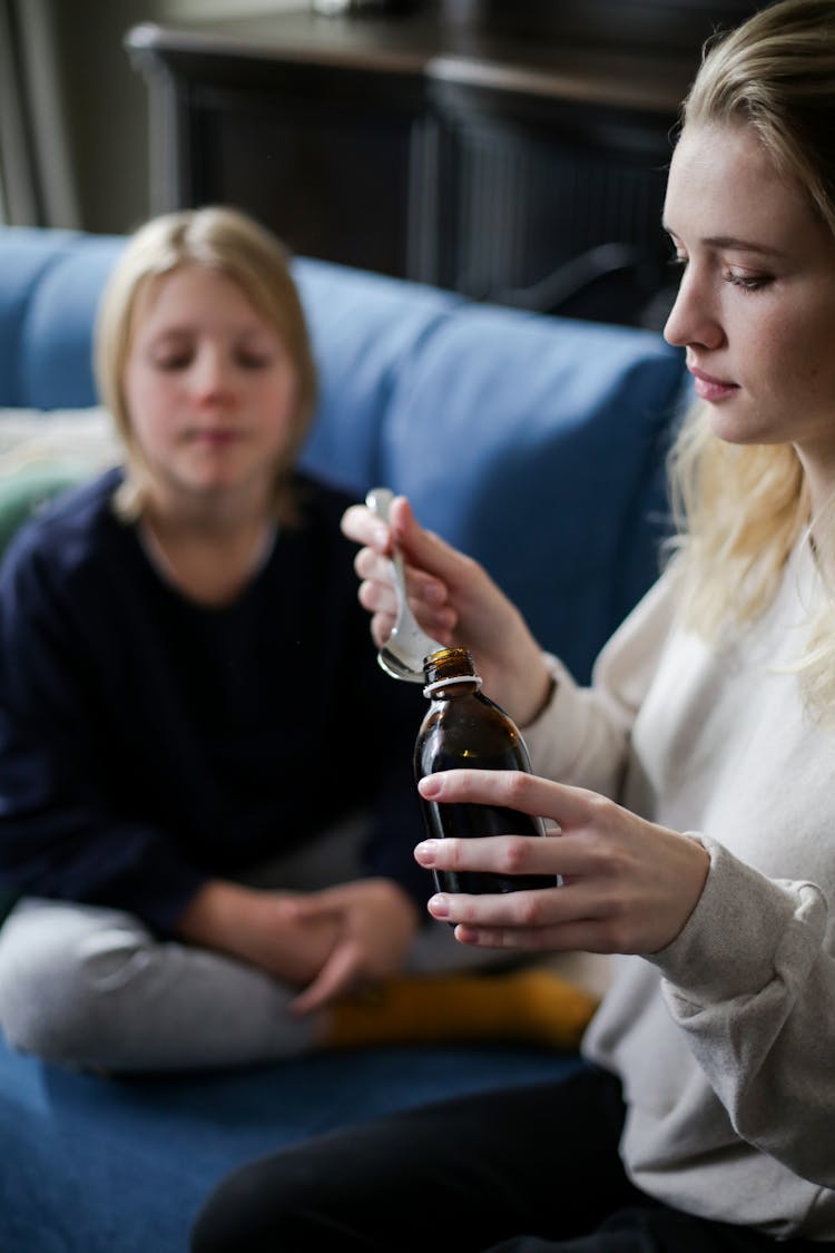 A Woman Holding A Bottle