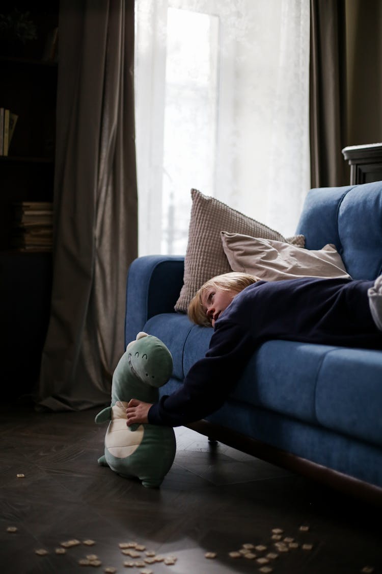 A Boy Lying On The Couch