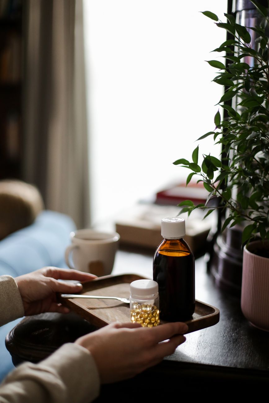 A cozy indoor setting with medicine bottles on a wooden tray, symbolizing home healthcare.