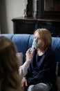 Woman in Blue Sweater Sitting on Couch