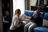 Woman in Gray Sweater Sitting on Gray Couch