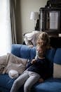 Girl in Blue Sweater Lying on Blue Sofa