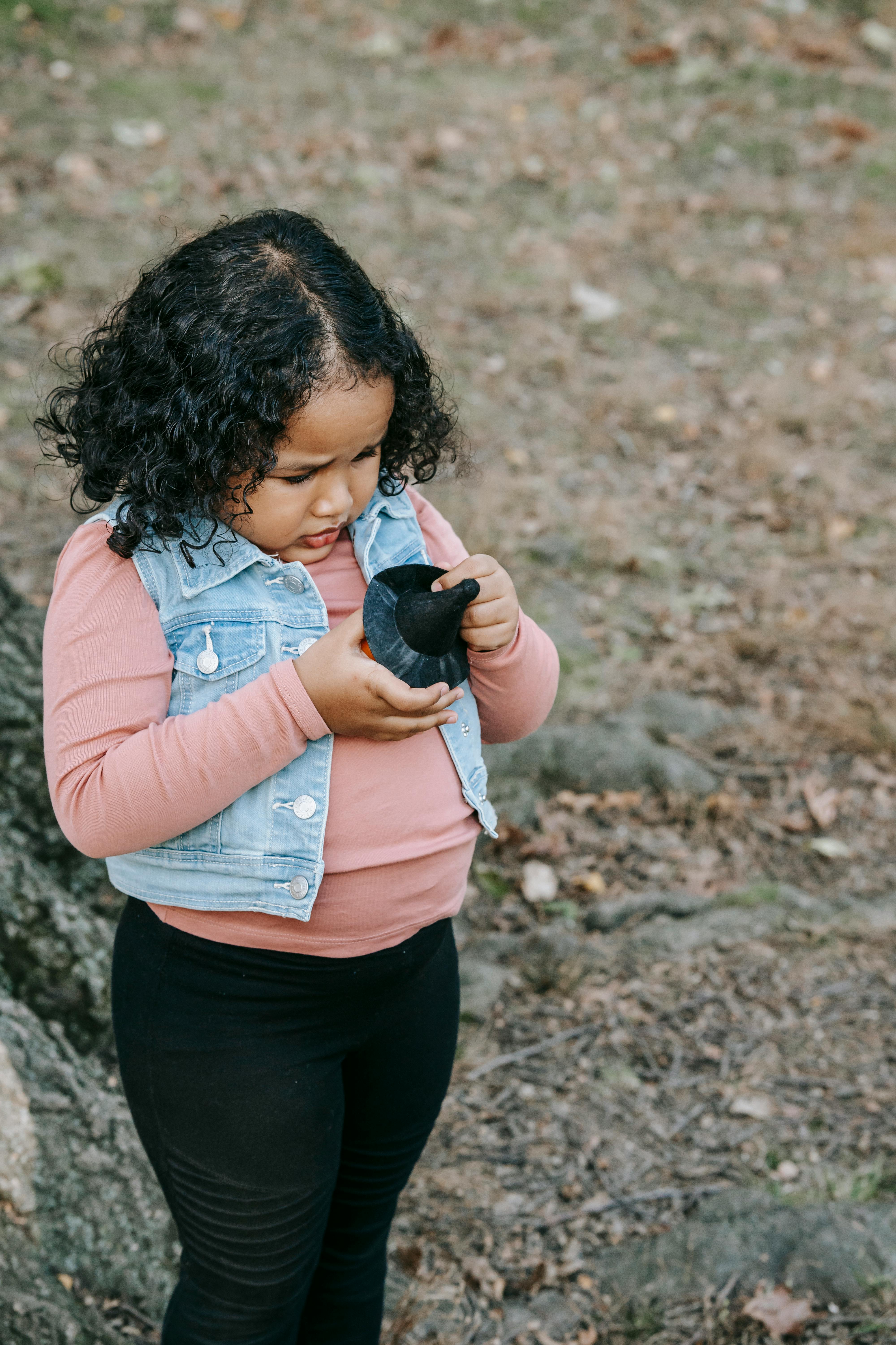 concentrated little girl with toy