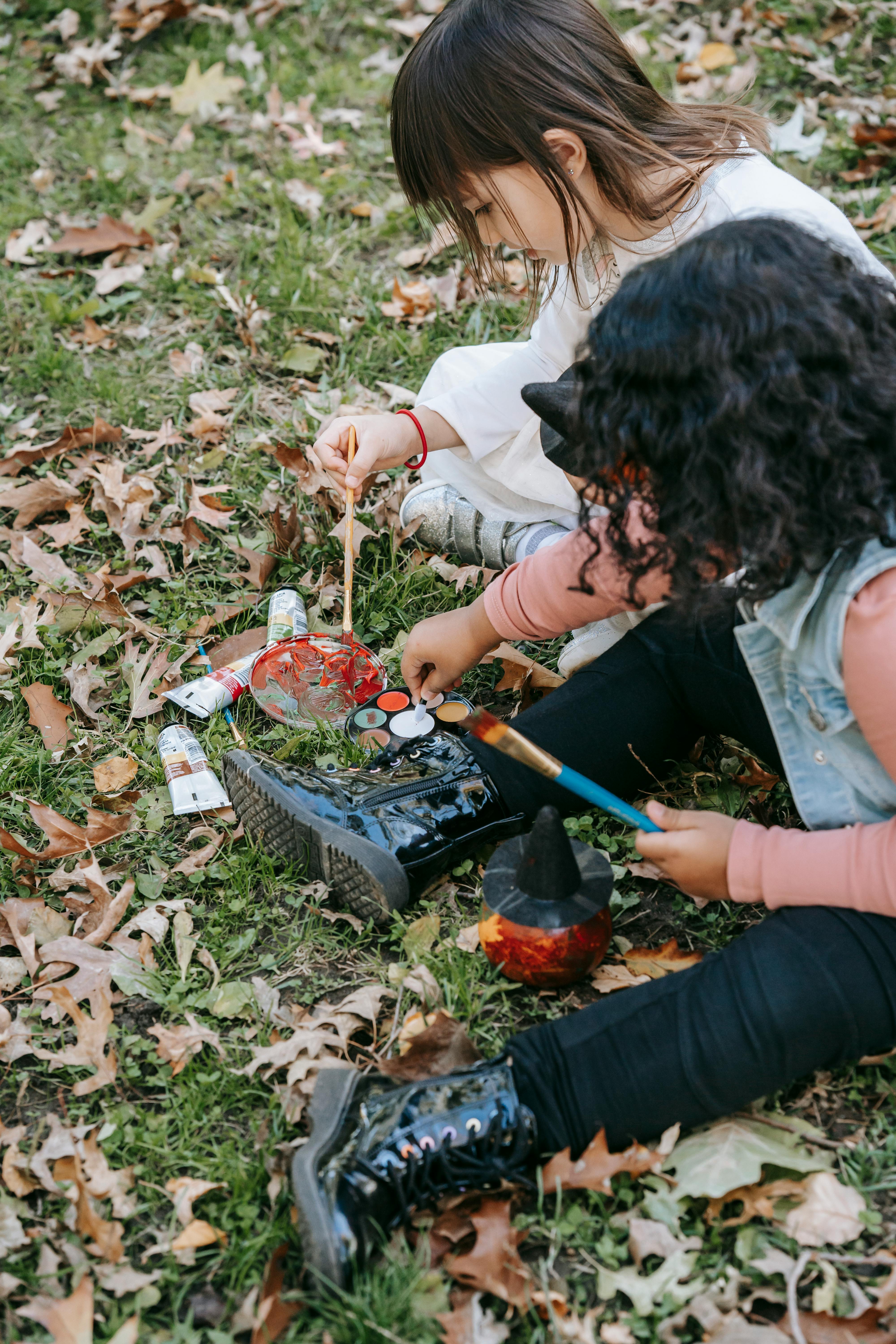 little diverse girls painting together with colorful paints