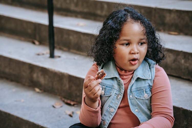 Black Girl Eating Bat Shaped Cookie