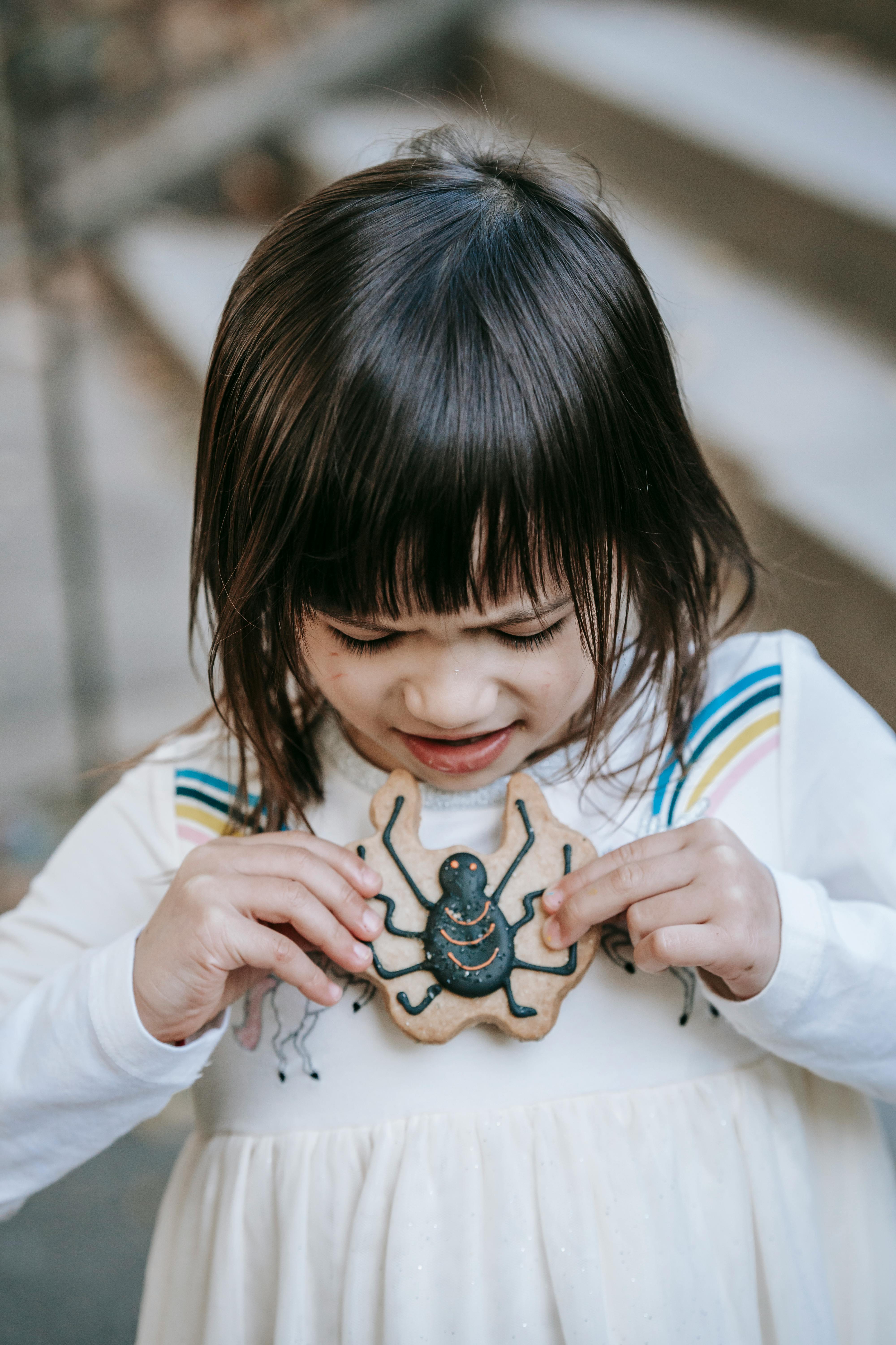 discontent girl with decorated cookie