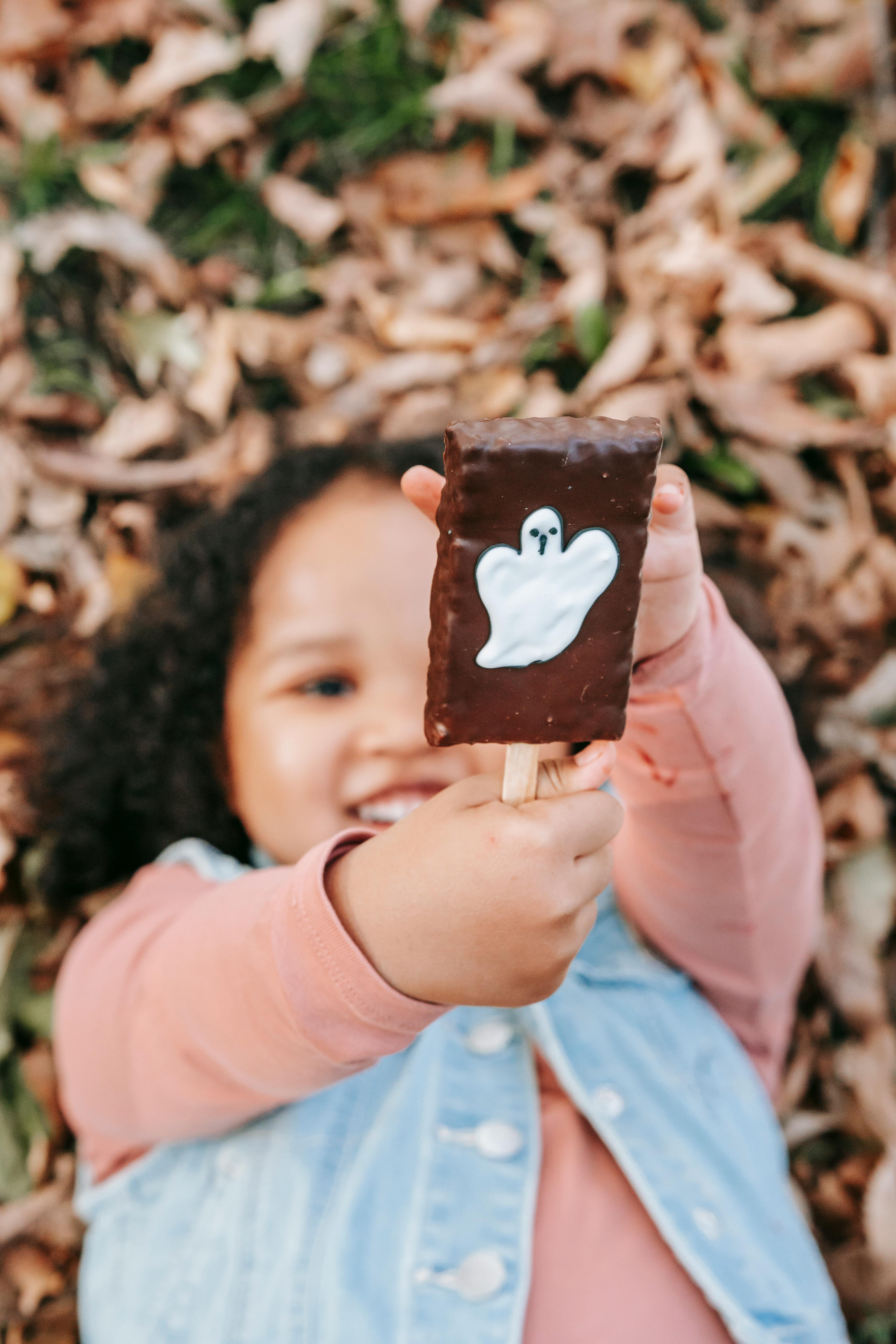 happy girl with sweet on stick