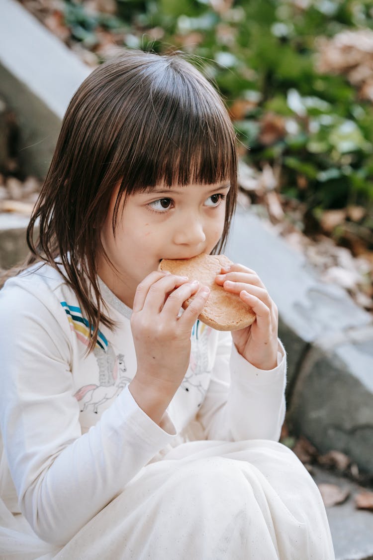 Hungry Adorable Girl With Cookie