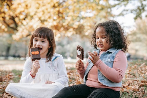 Cheerful children with sweets on stick