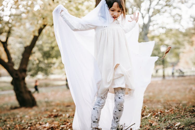 Smiling Girl Trying To Wear White Cloth