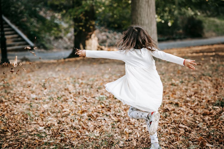 Carefree Girl Spinning In Park