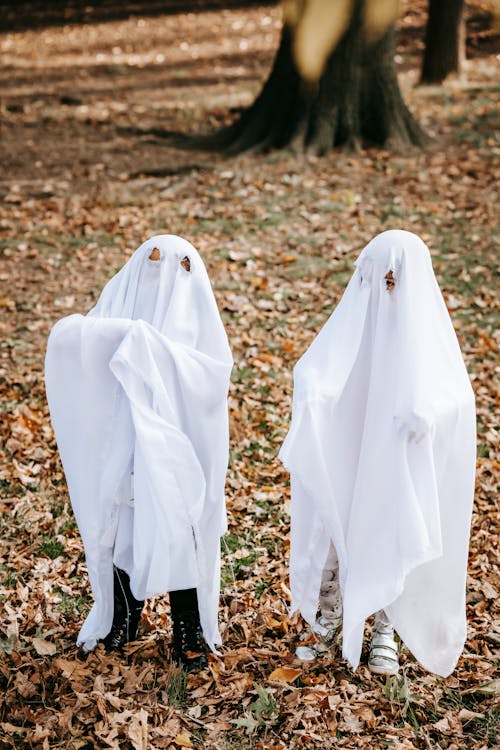 Anonymous children wearing ghost costumes