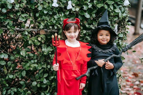 Free Cute multiracial girls in Halloween costumes Stock Photo