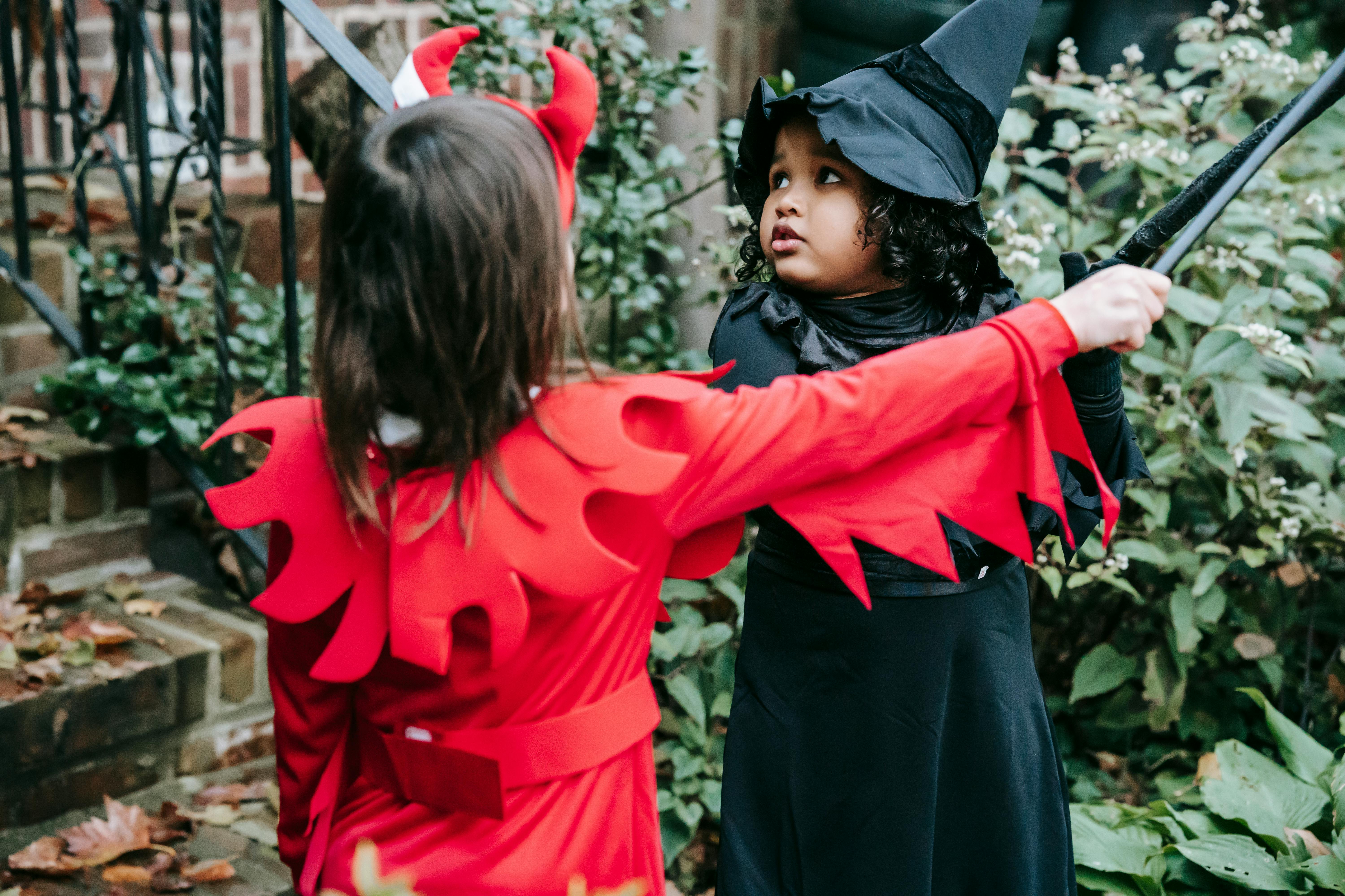 cute girls in costumes near entrance of building