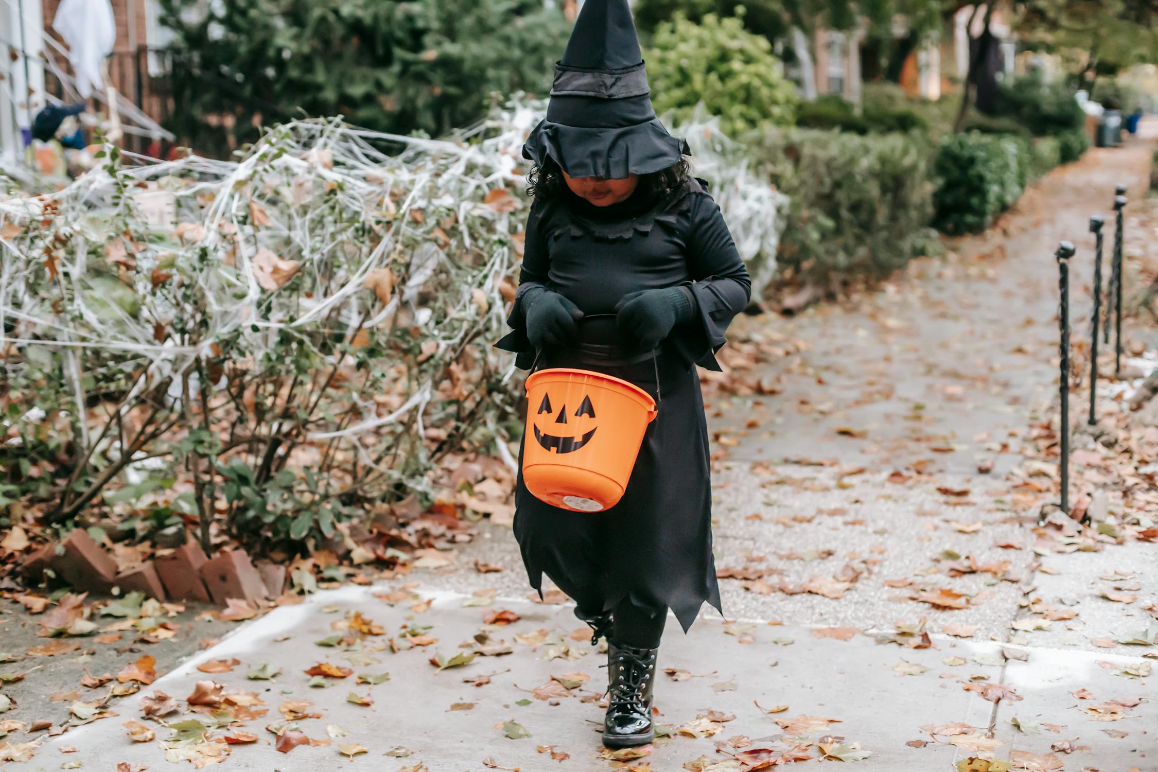 Faceless Child Trick Or Treating In Street In Witch Costume · Free