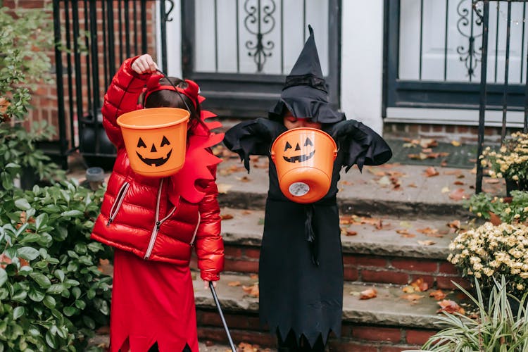 Faceless Kids Strolling On Halloween In Witch And Devil Costume