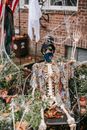 Skeleton sitting near house in Halloween day