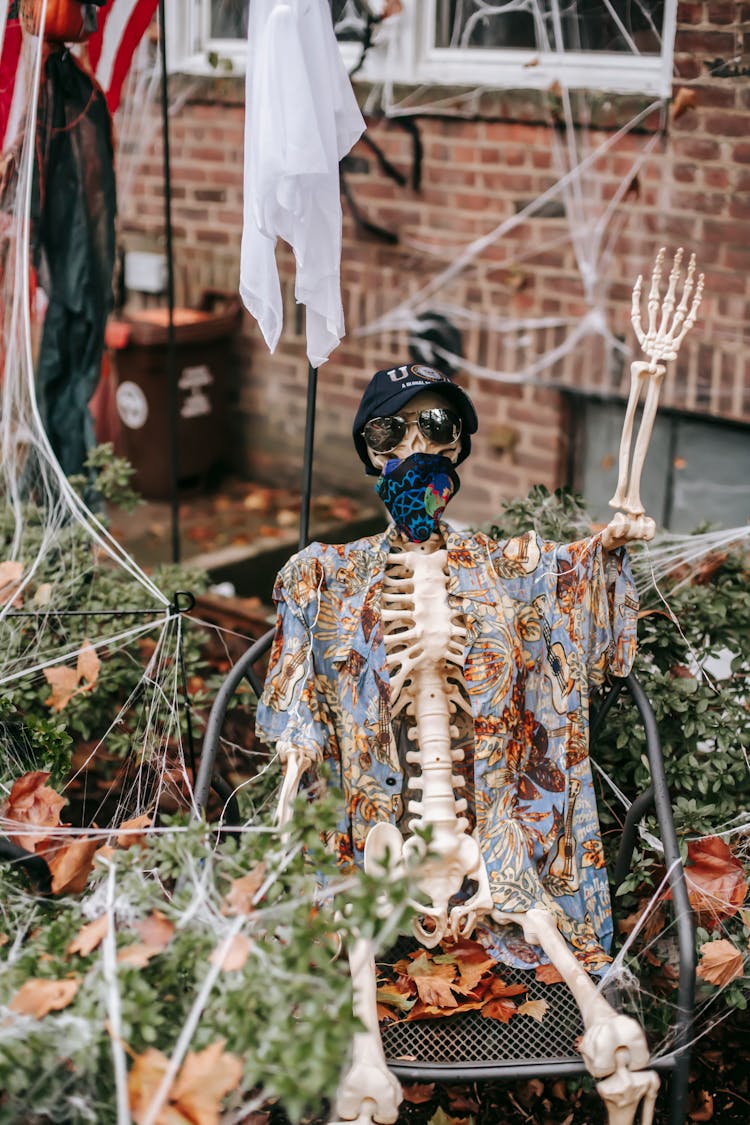 Skeleton Sitting Near House In Halloween Day