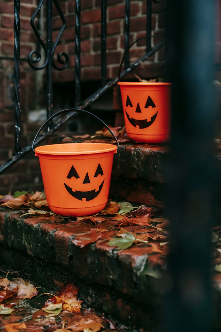 Orange Buckets With Halloween Symbols Outside House