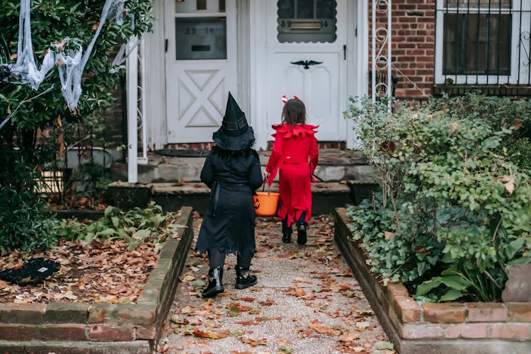 Kids In Halloween Outfits Playing Trick Or Treat