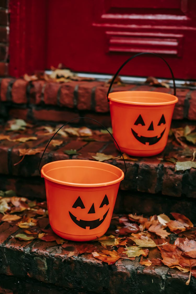 Orange Buckets Placed On Stairs Near House