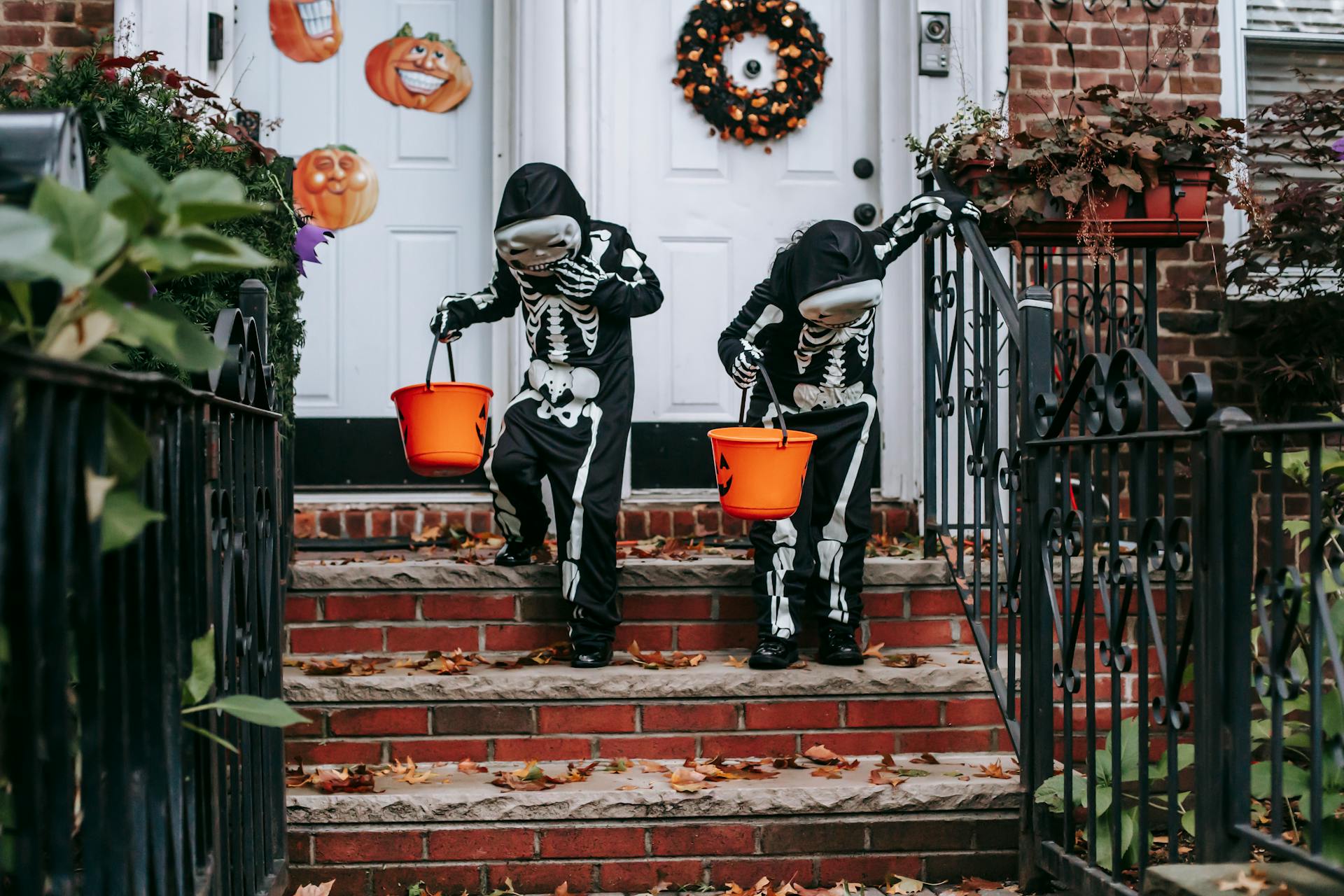 Unrecognizable children in Halloween costumes trick or treating together