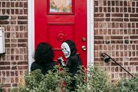 Faceless children trick or treating in Halloween costumes