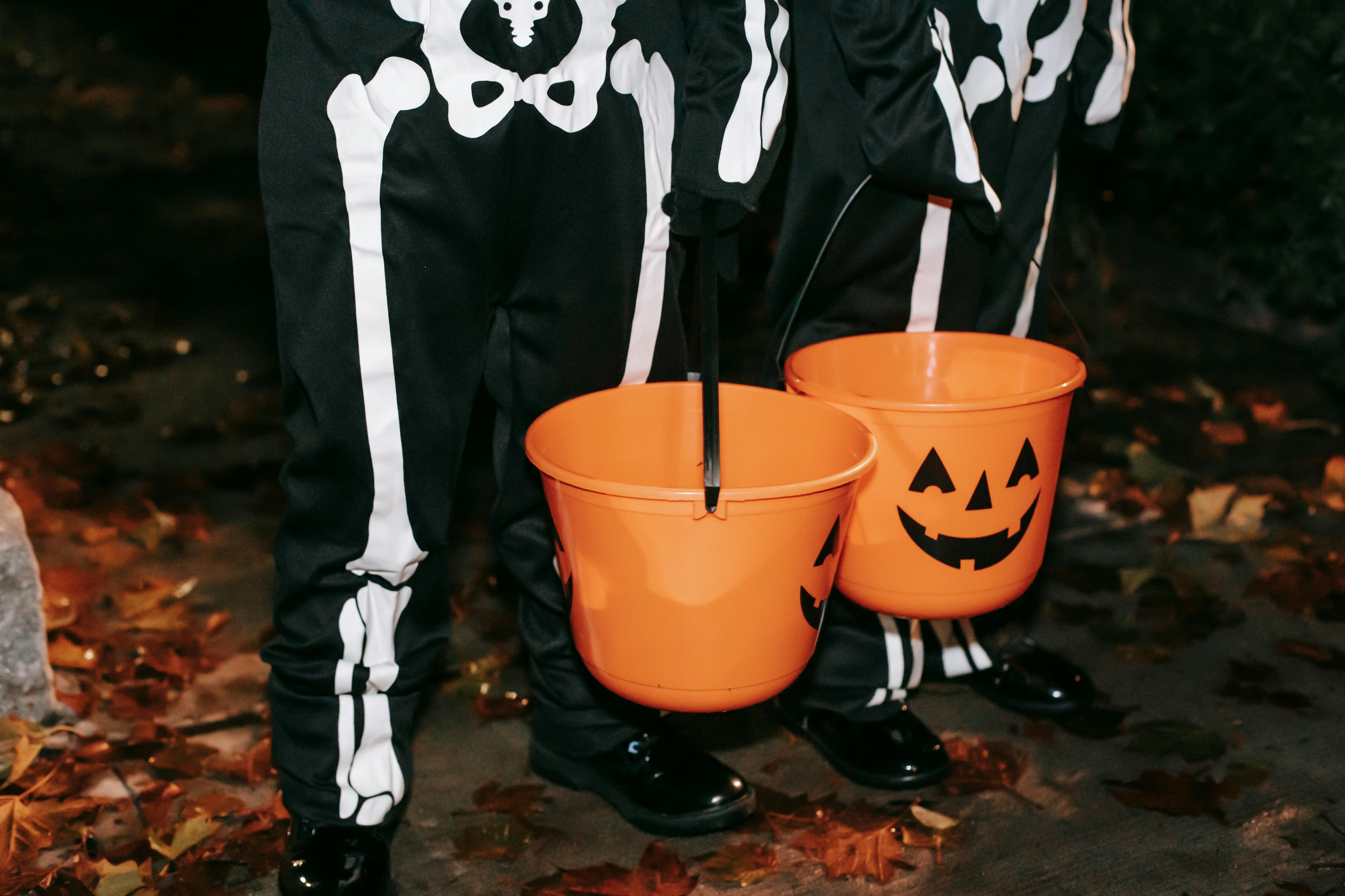 Crop kids with jack buckets on street · Free Stock Photo