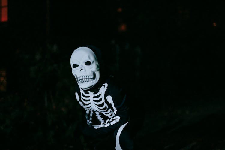 Anonymous Child In Mask And Costume In Forest