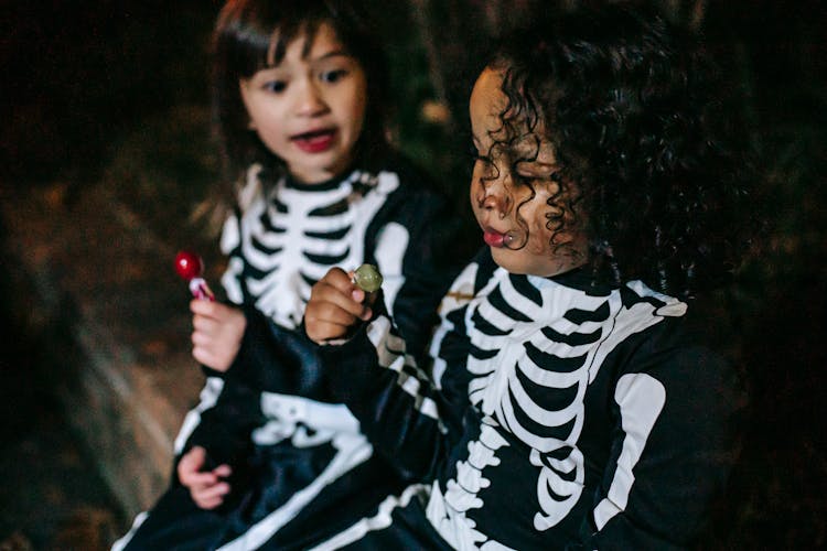 Crop Charming Multiracial Girlfriends With Lollipops On Halloween Night