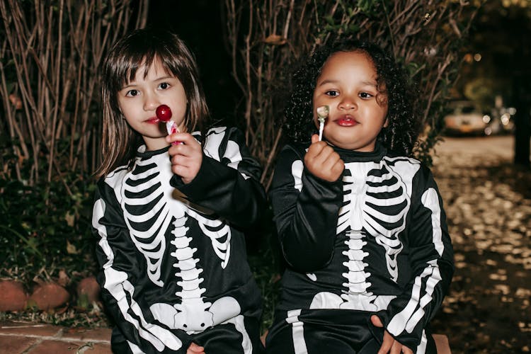 Diverse Children With Delicious Lollipops On Halloween Night