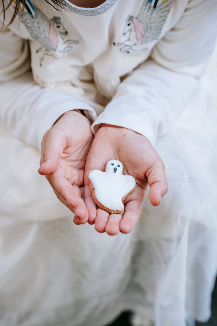 Crop Faceless Girl Demonstrating Ghost Cookie On Hand