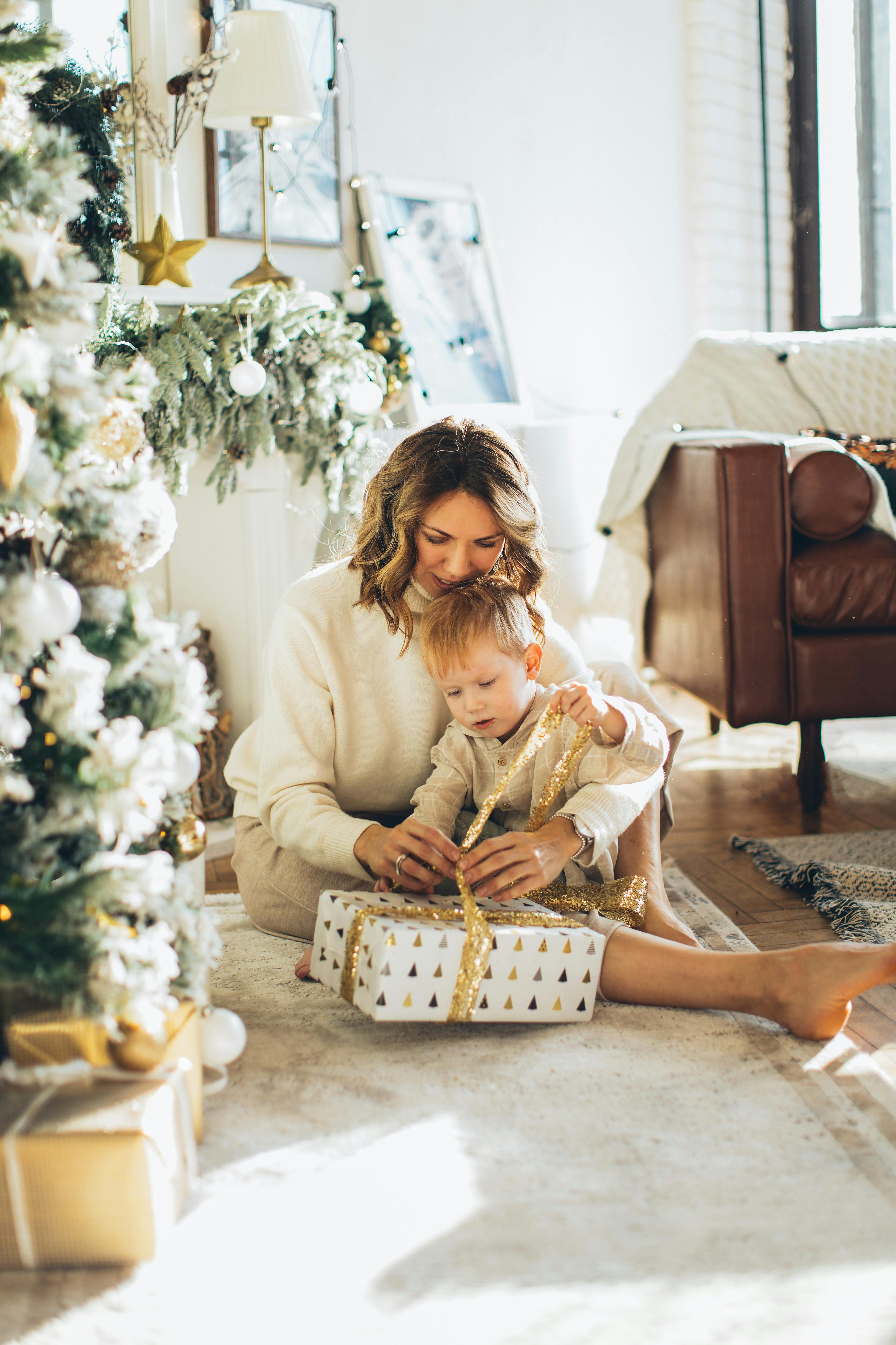woman and child opening a christmas gift