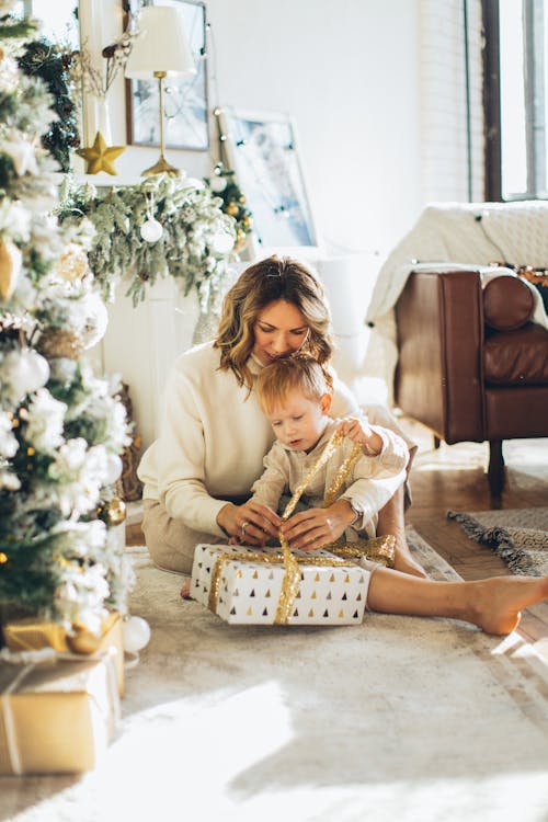 Woman and Child Opening a Christmas Gift