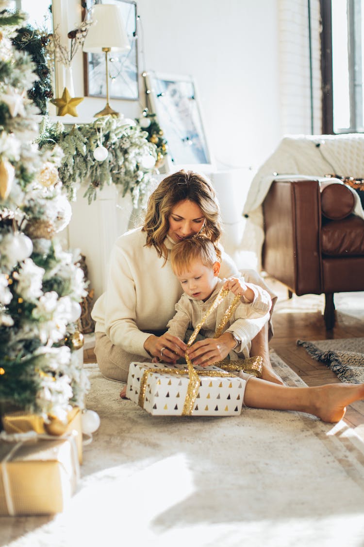 Woman And Child Opening A Christmas Gift