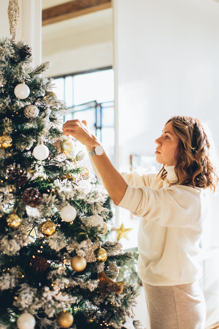 Woman Decorating A Christmas Tree